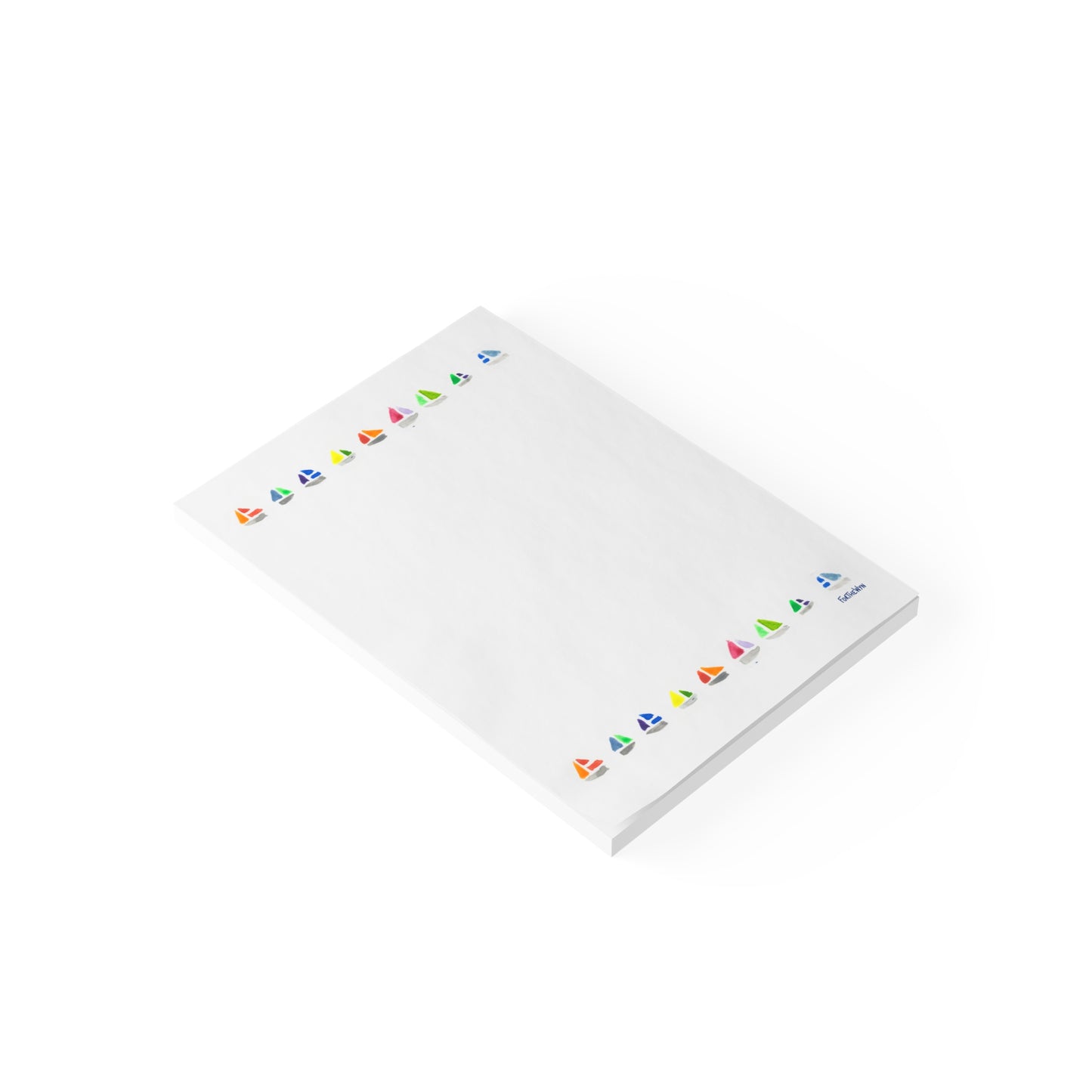 White notepad with colorful sailboat motifs on a white background