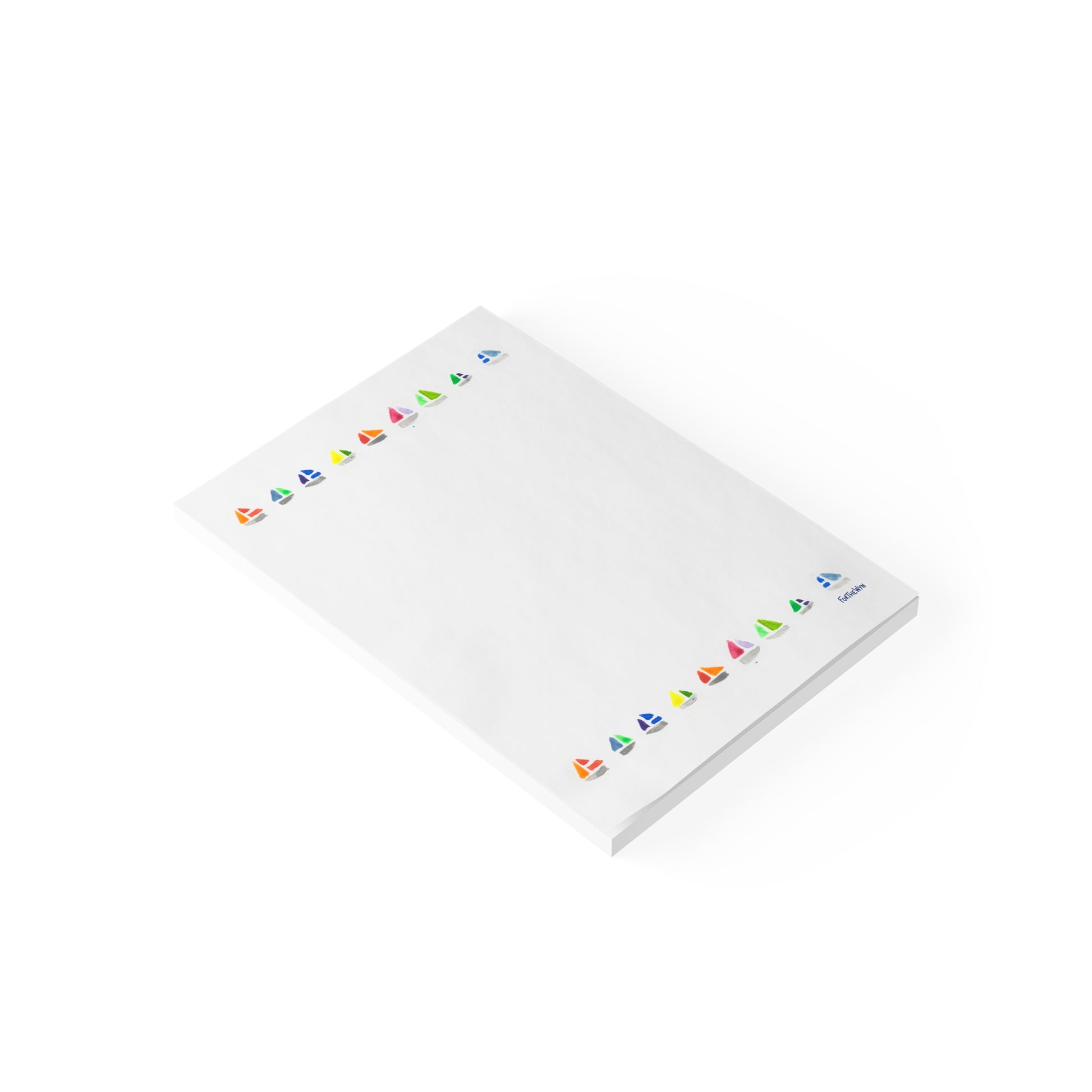 White notepad with colorful sailboat motifs on a white background